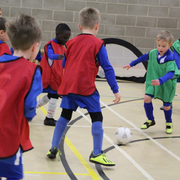 Children playing football at KWMCC Sports Hall